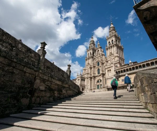 Camino guided tours from Ireland Xacobeo group travel pilgrims arriving at Santiago de Compostela cathedral Camino de Santiago JWT travel tours